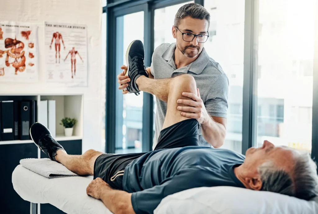 physiotherapist maneuvering his patient's knee to test the range of motion