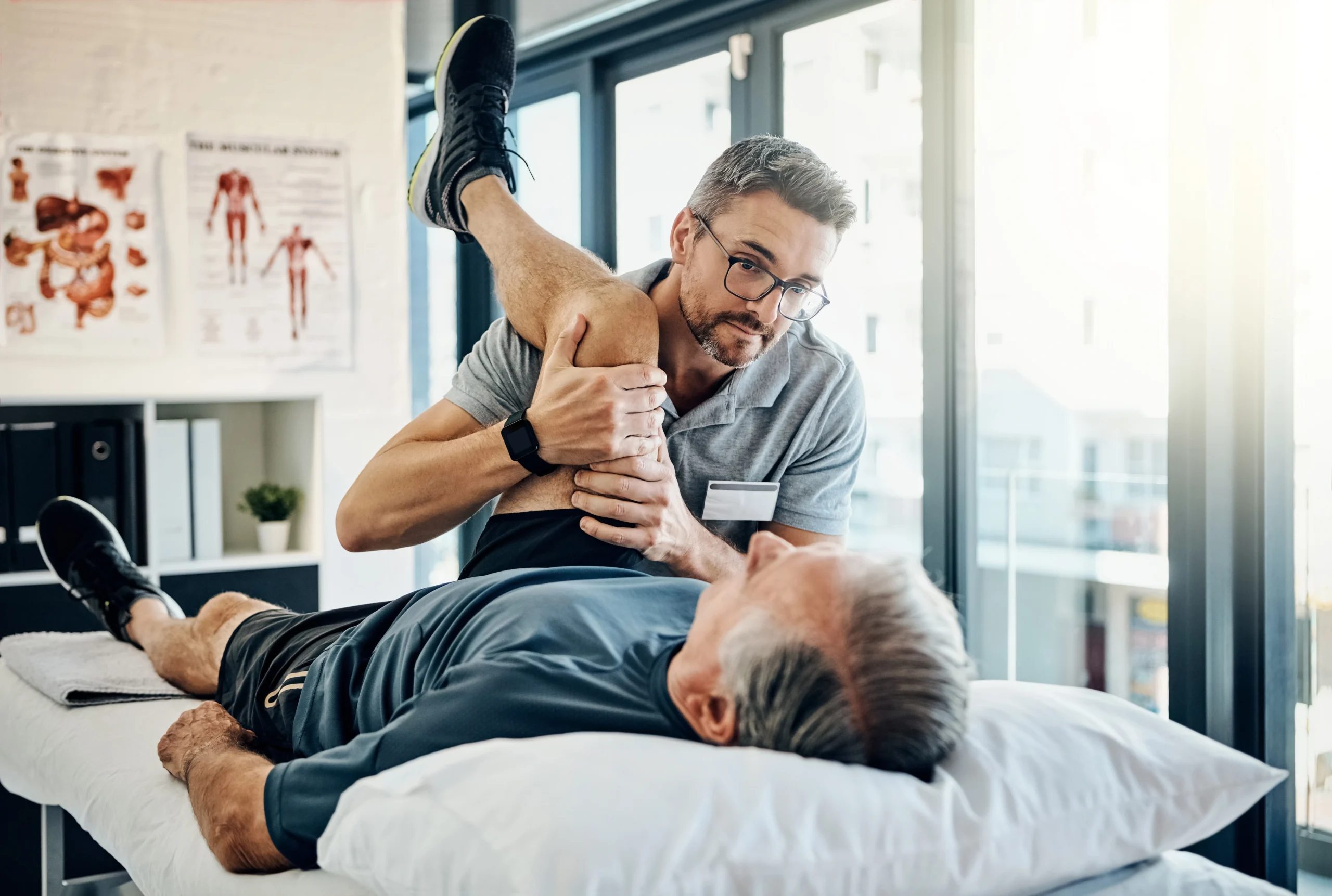 physiotherapist stretching his patient's knee to help treat knee pain